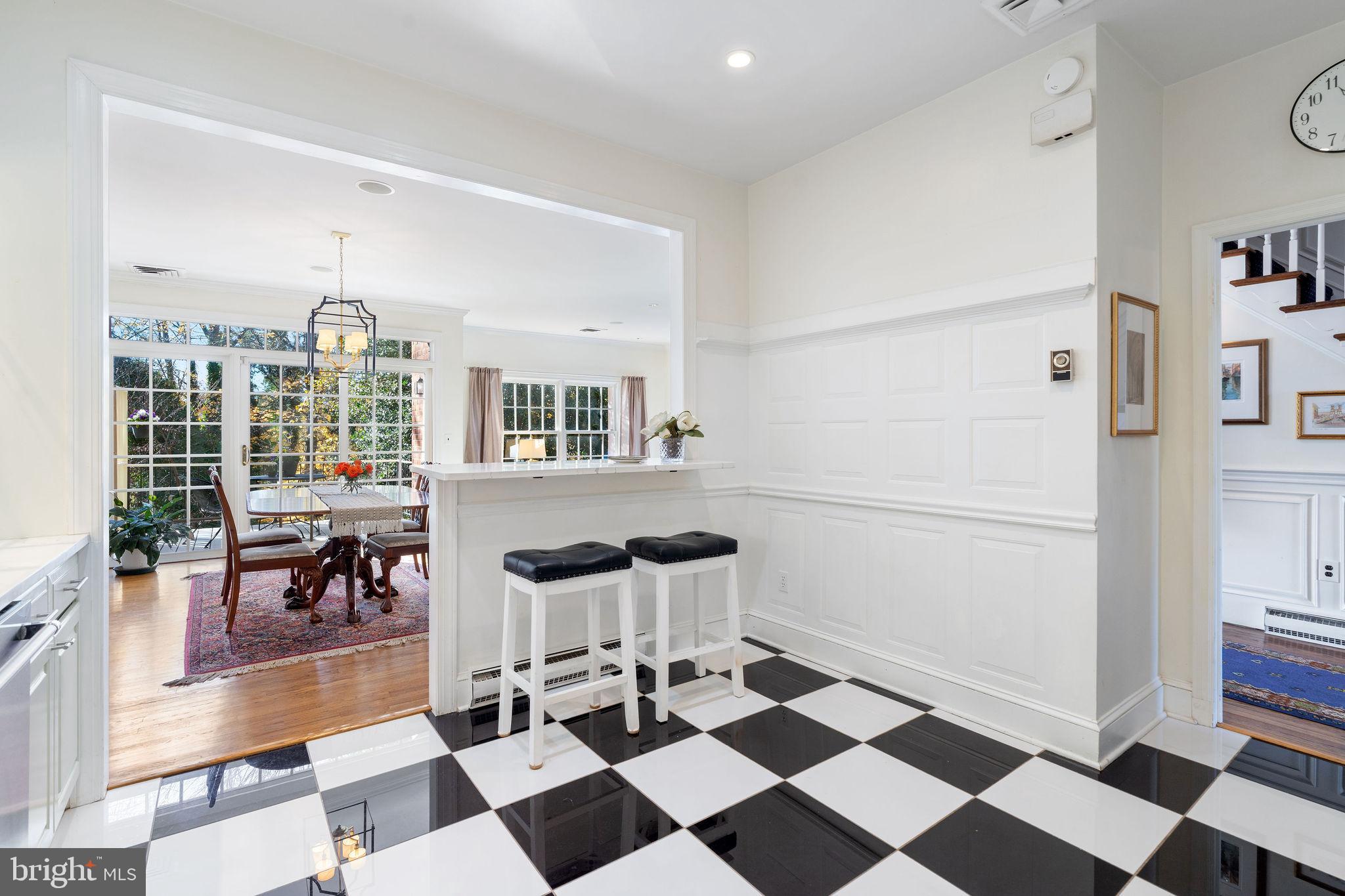 8007 Strauff Road, Unit 16 Towson, MD 21204 - Photo 16 of 49 a living room with a black white checkered floor with couches chair and fire place next to a window