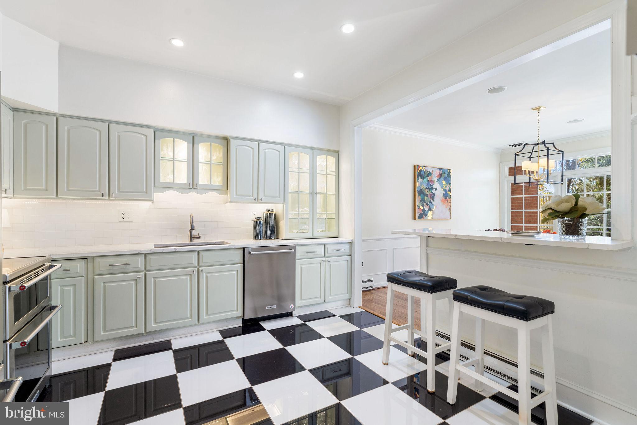 8007 Strauff Road, Unit 16 Towson, MD 21204 - Photo 17 of 49 a kitchen with a sink a dining table and chairs