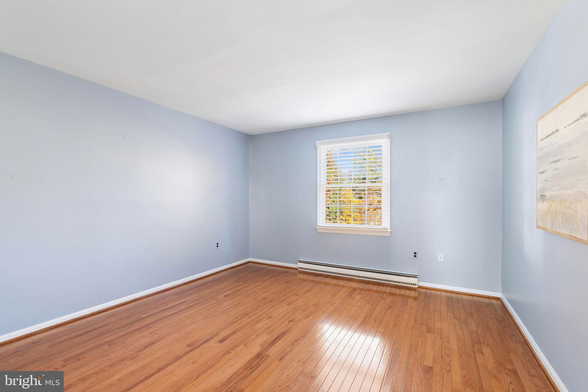 8007 Strauff Road, Unit 16 Towson, MD 21204 - Photo 32 of 49 an empty room with wooden floor and windows