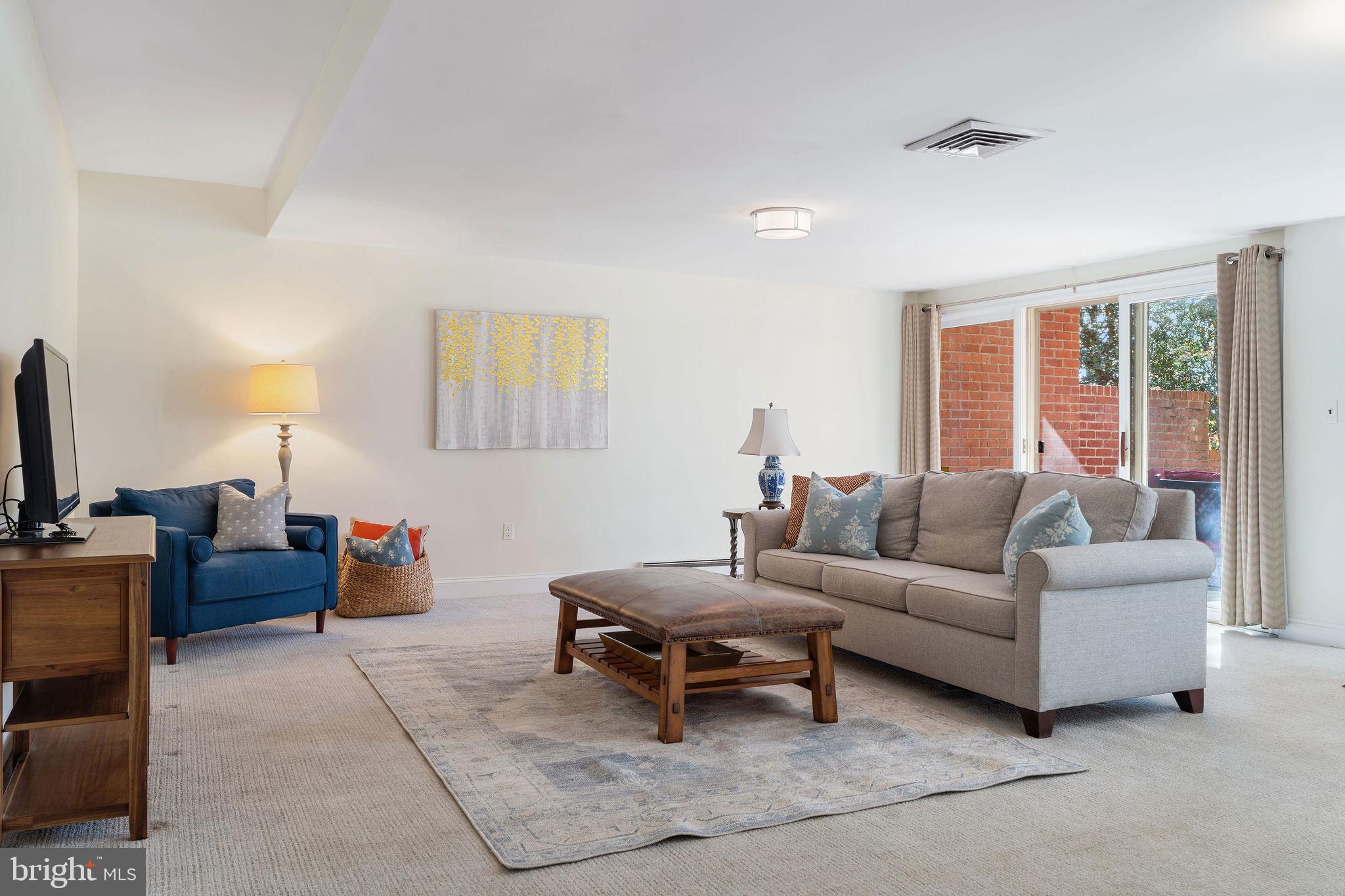 8007 Strauff Road, Unit 16 Towson, MD 21204 - Photo 35 of 49 a living room with furniture a flat screen tv and a window
