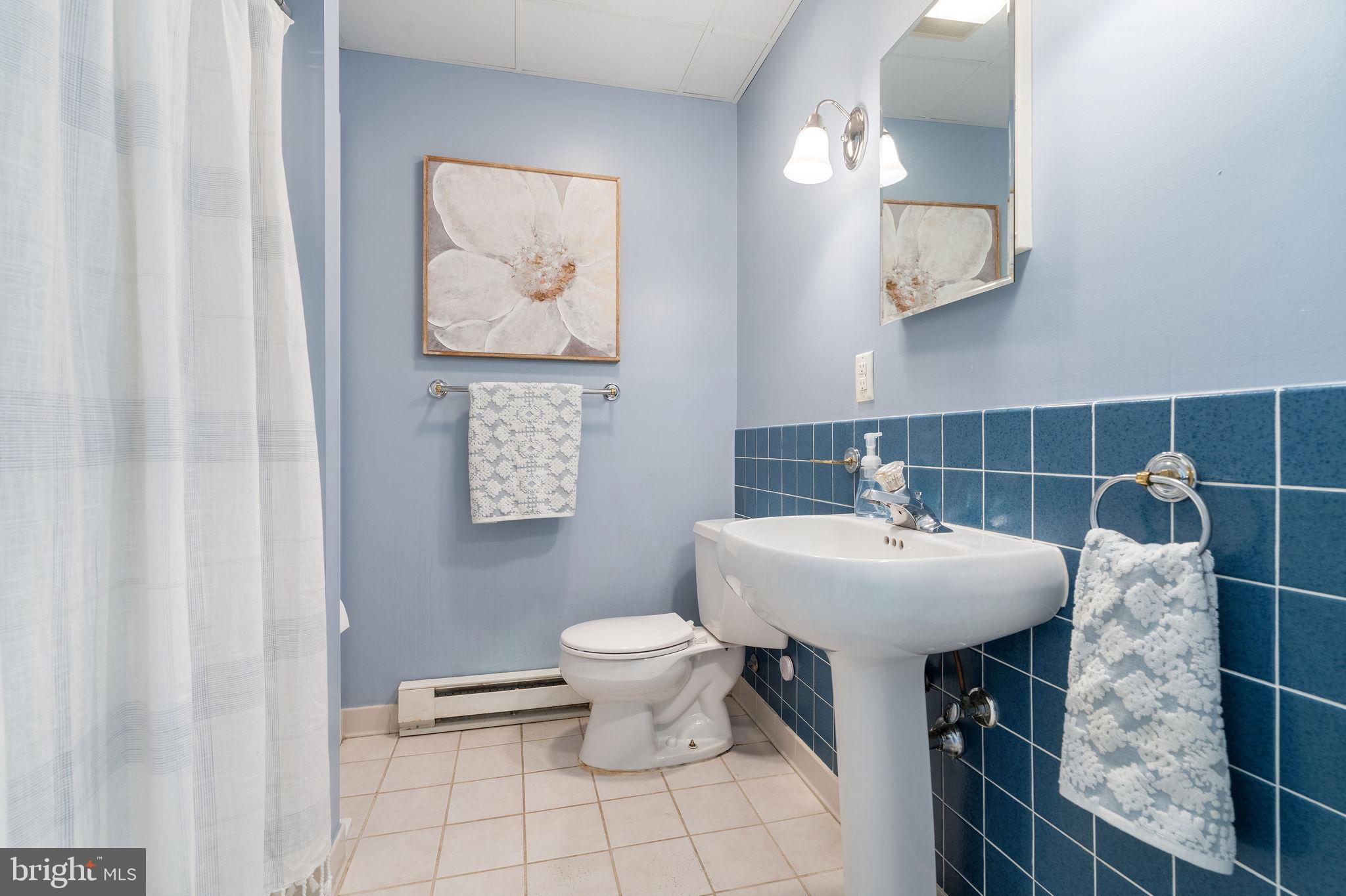 8007 Strauff Road, Unit 16 Towson, MD 21204 - Photo 40 of 49 a bathroom with a toilet a sink and mirror