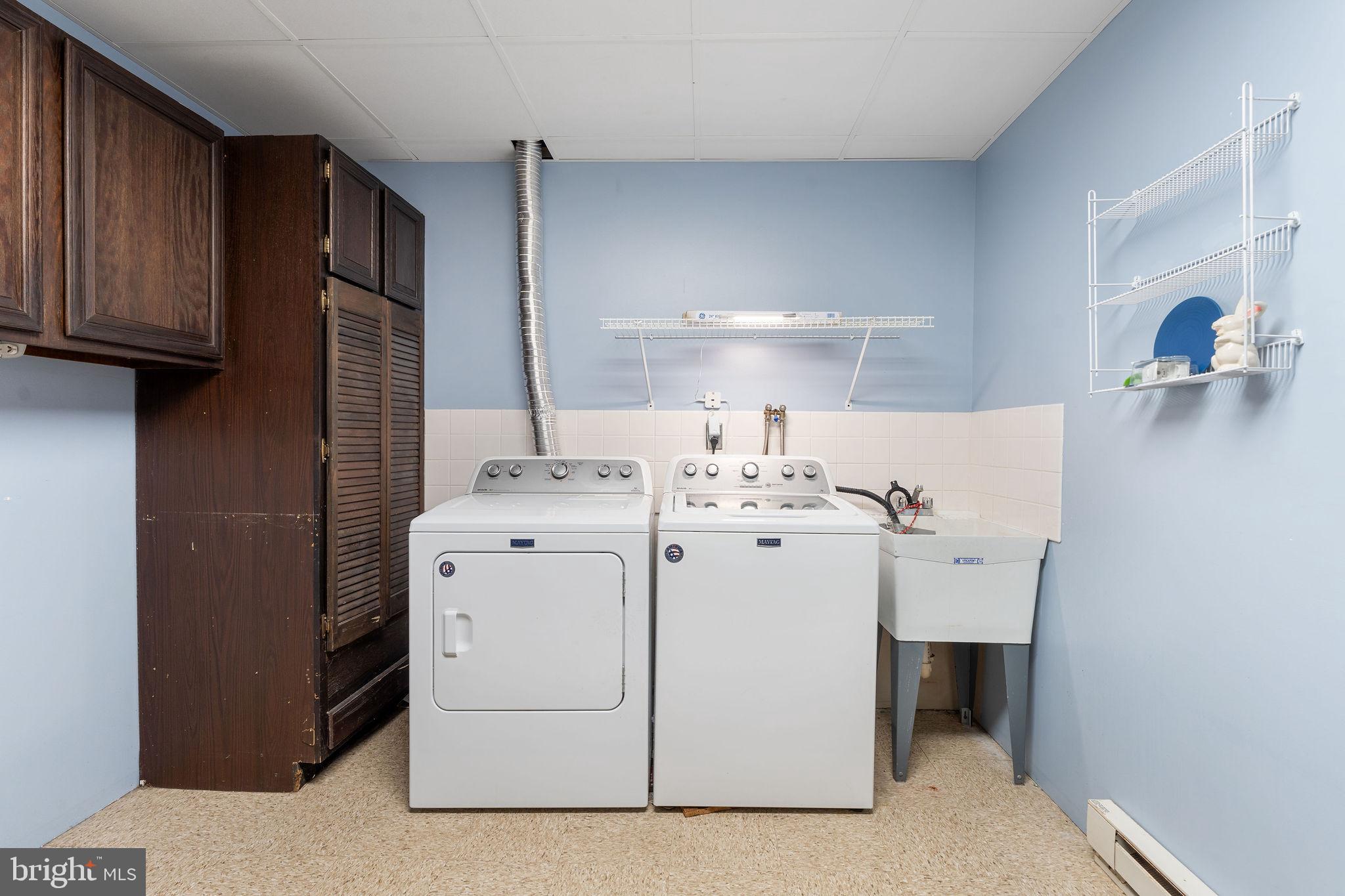 8007 Strauff Road, Unit 16 Towson, MD 21204 - Photo 41 of 49 a utility room with cabinets washer and dryer