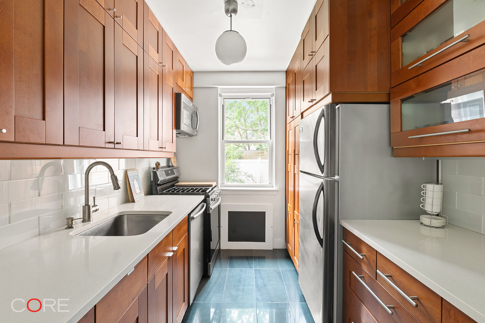 3725 Henry Hudson Parkway West, Unit 2F/2G Bronx, NY 10463 - Photo 3 of 10 a kitchen with stainless steel appliances granite countertop a refrigerator a sink dishwasher a stove and a sink with wooden cabinets