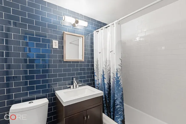 a bathroom with a sink shower and a mirror