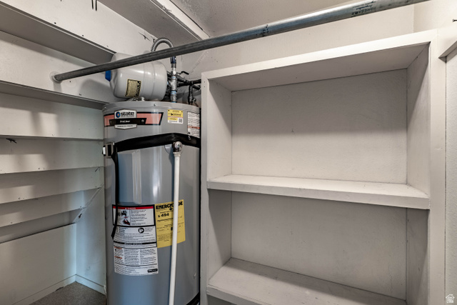 728 400 East Orem, UT 84097 - Photo 30 of 30 Water heater with an expansion tank and adjacent built-in shelving