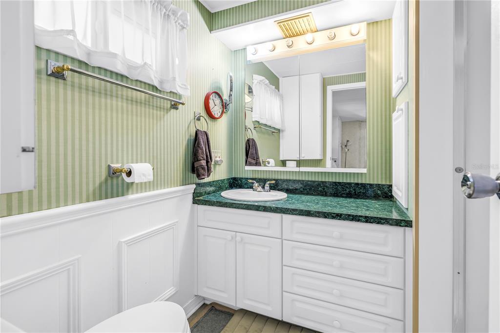 1100 South Belcher Road, Unit 502 Largo, FL 33771 - Photo 20 of 51 a bathroom with a granite countertop sink and a mirror