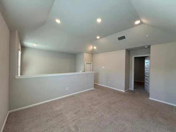 an empty room with windows and closet