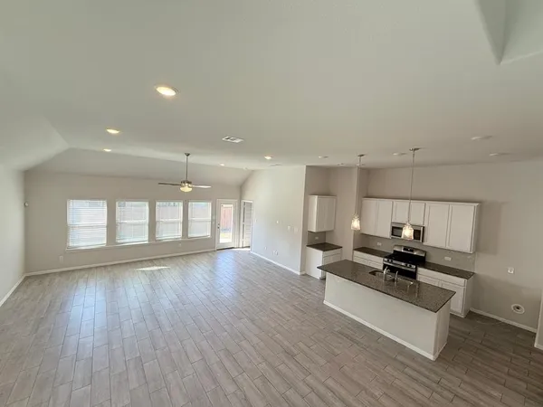 a view of kitchen with sink and wooden floor
