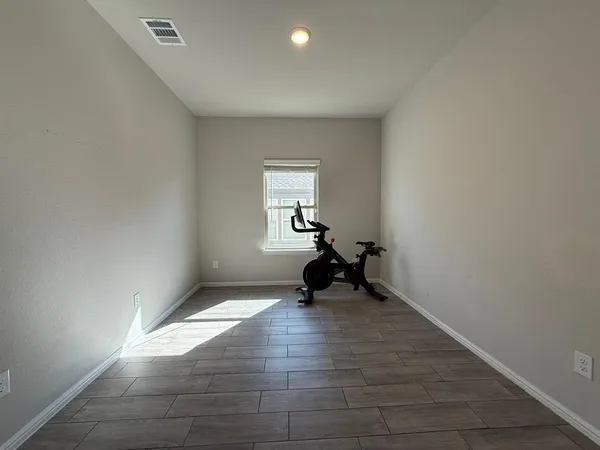 a view of an empty room and wooden floor