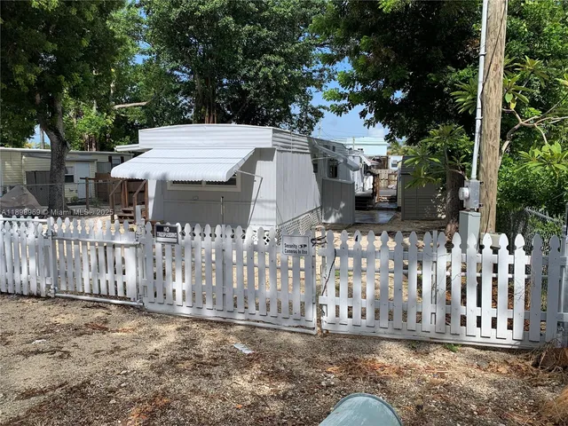 a view of a house with wooden fence