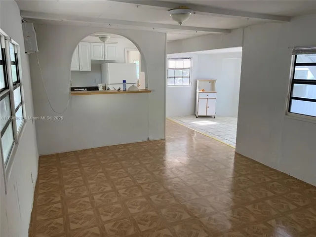 an empty room with cabinet and mirror