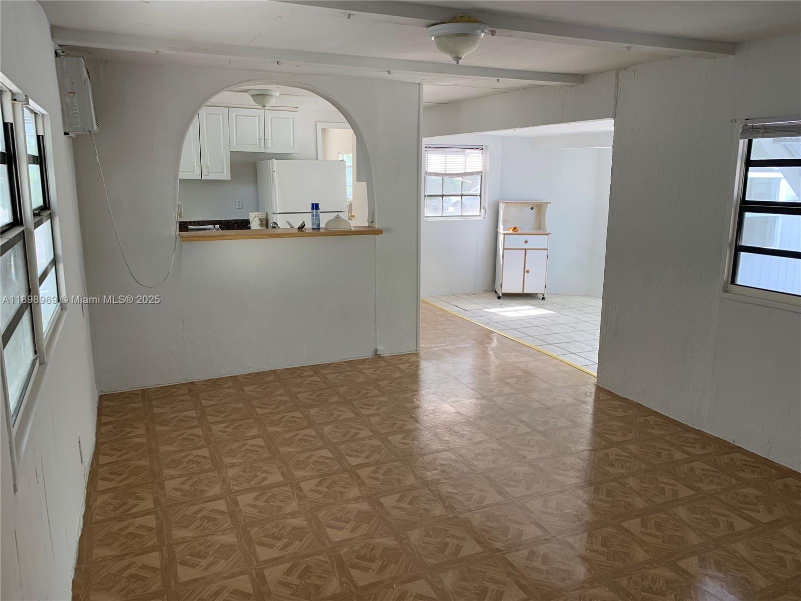 740 Largo Road, Unit 740 Key Largo, FL 33037 - Photo 5 of 7 an empty room with cabinet and mirror