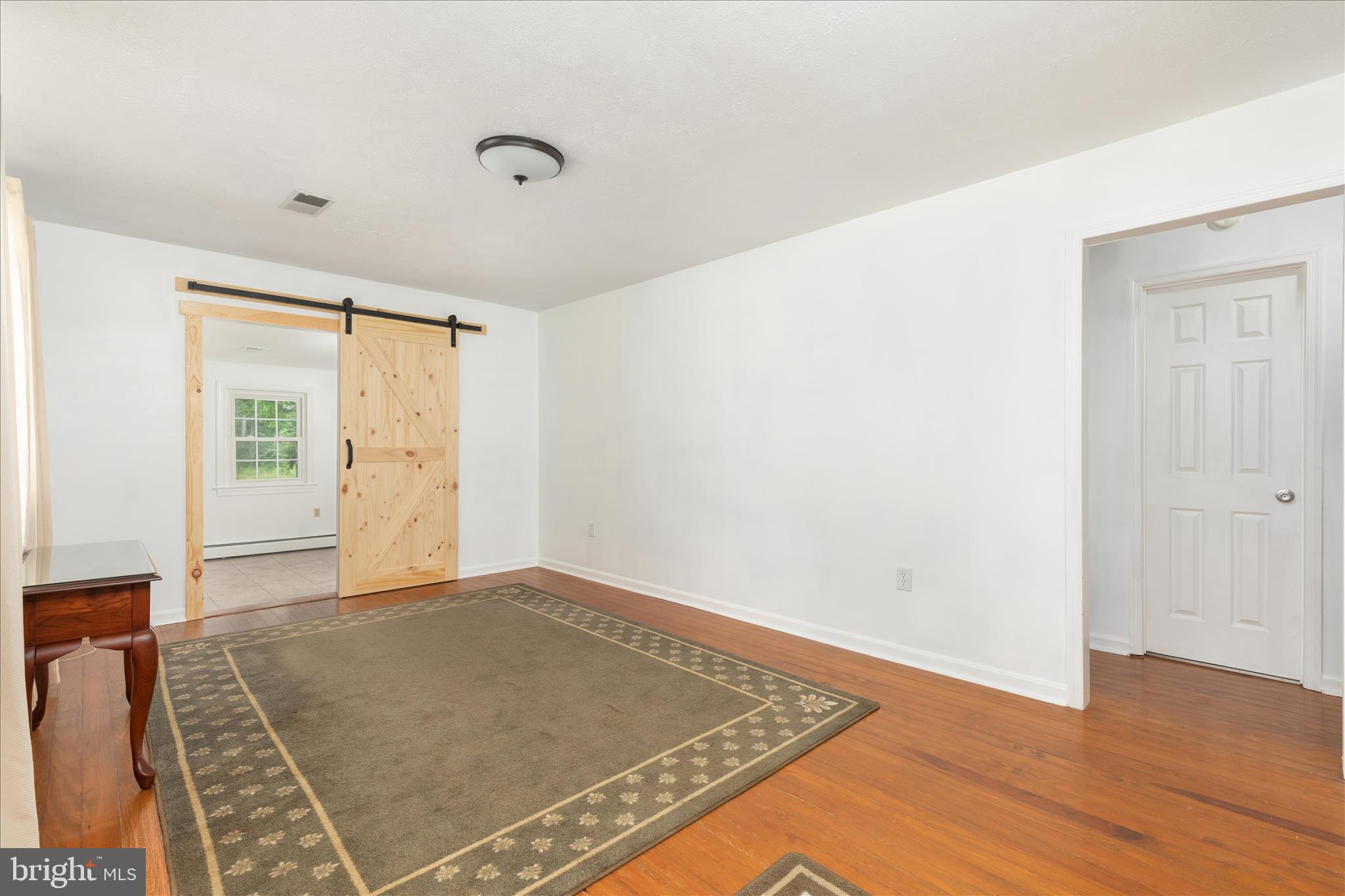 1488 Millner Road Strasburg, VA 22657 - Photo 6 of 44 Living room with barn door into primary bedroom