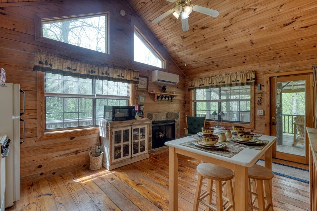 746 High Ridge Road Murphy, NC 28906 - Photo 20 of 44 a kitchen with stainless steel appliances kitchen island granite countertop a stove a refrigerator a dining table and chairs with wooden floor