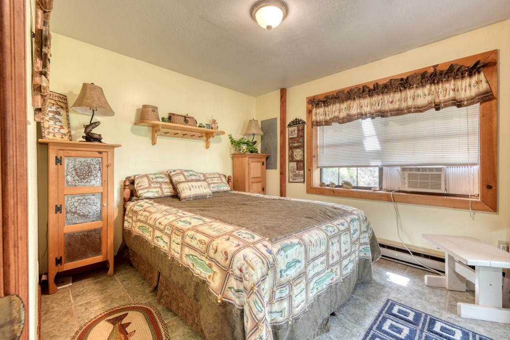746 High Ridge Road Murphy, NC 28906 - Photo 33 of 44 a bedroom with a bed and wooden floor