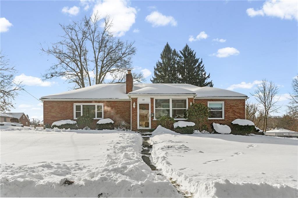 a view of a house with a snow in the yard