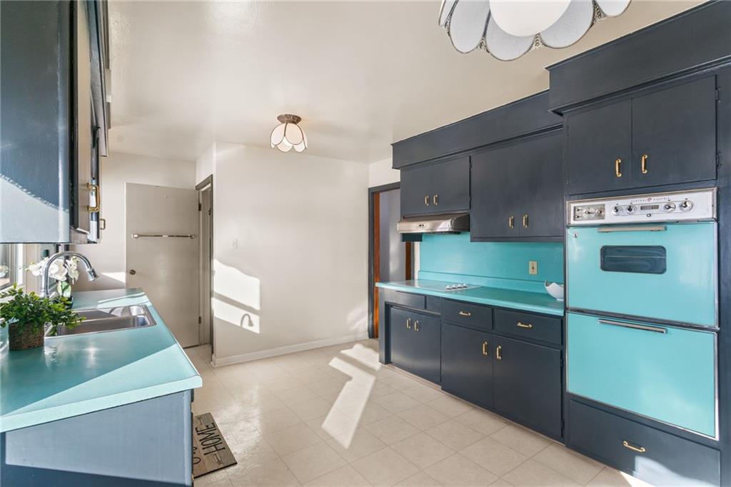 738 Addis Street New Castle, PA 16101 - Photo 12 of 50 a kitchen with kitchen island a sink stainless steel appliances and cabinets