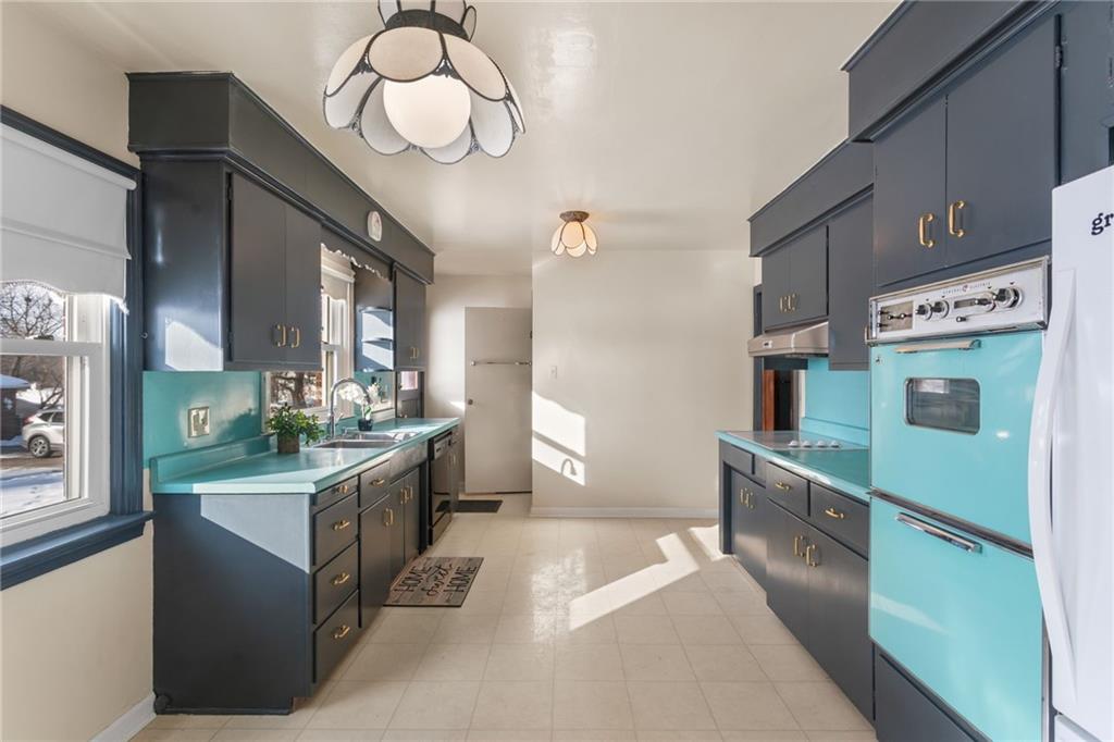 738 Addis Street New Castle, PA 16101 - Photo 13 of 50 a kitchen with stainless steel appliances granite countertop a stove a sink a refrigerator and a refrigerator
