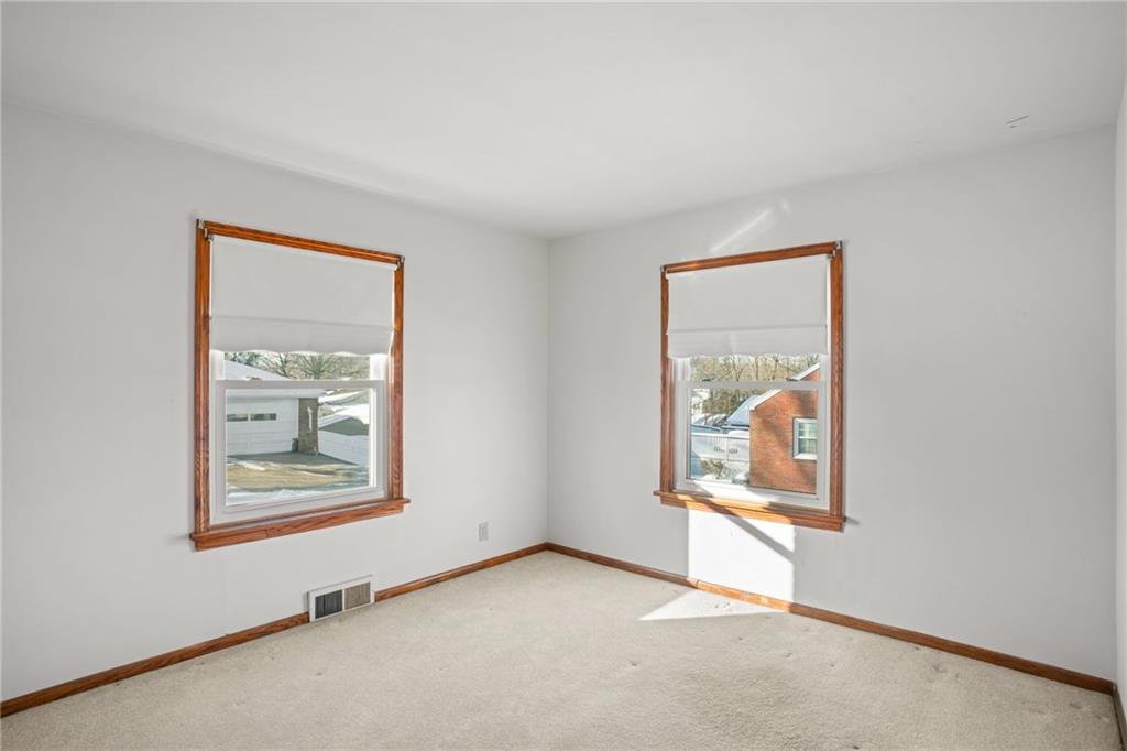 738 Addis Street New Castle, PA 16101 - Photo 32 of 50 an empty room with windows and painting on the wall