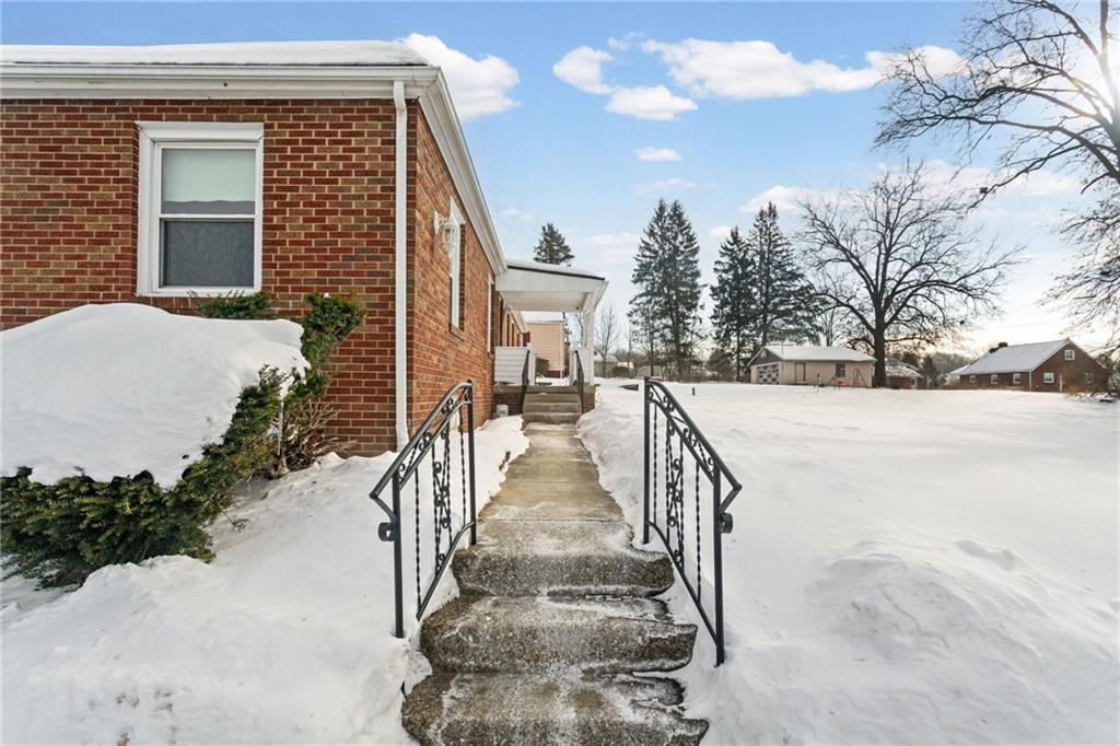 738 Addis Street New Castle, PA 16101 - Photo 44 of 50 a view of a brick house with large windows and a small yard