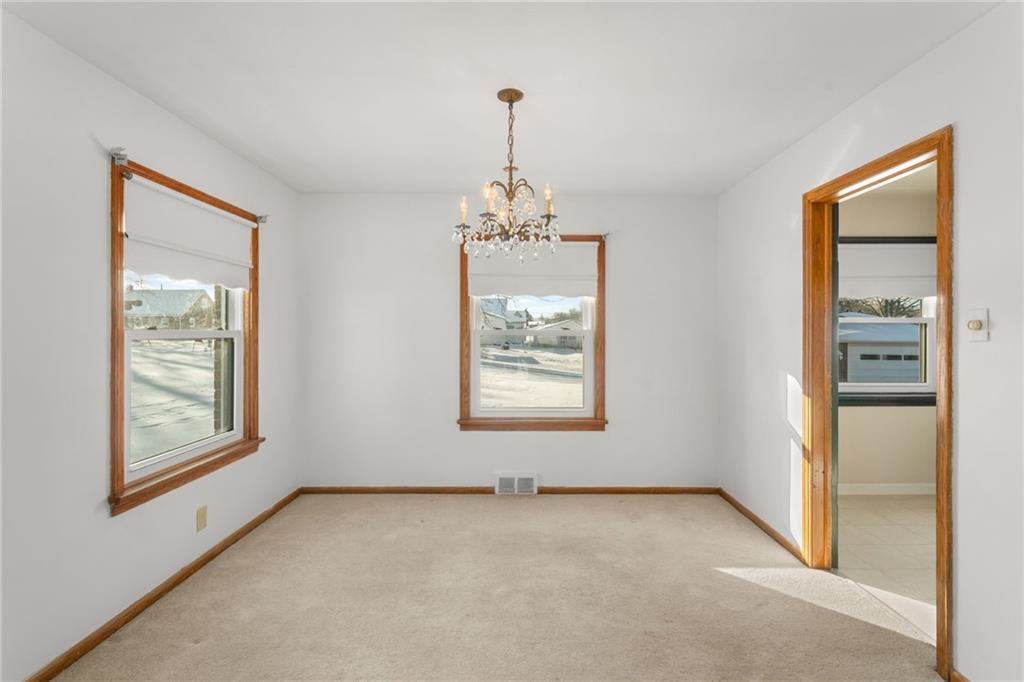 738 Addis Street New Castle, PA 16101 - Photo 9 of 50 en empty room with windows and chandelier
