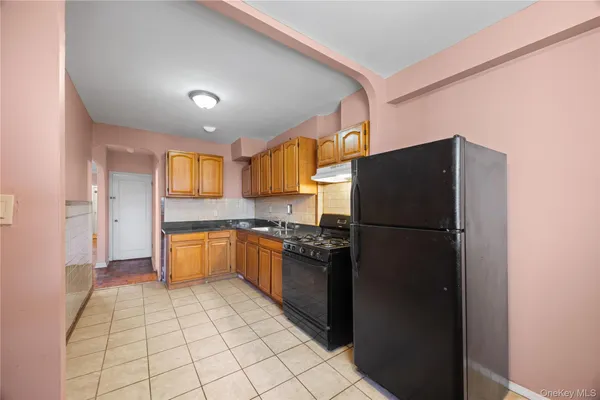 a kitchen with a refrigerator and a sink