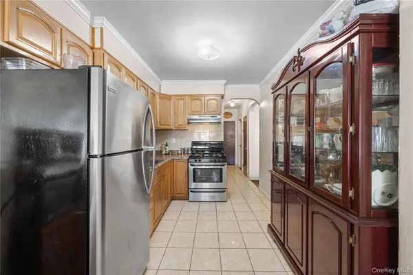 a kitchen with stainless steel appliances granite countertop a refrigerator and a stove
