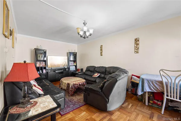 a living room with furniture a couch and chandelier