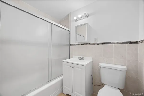 a bathroom with a toilet a sink and bathtub