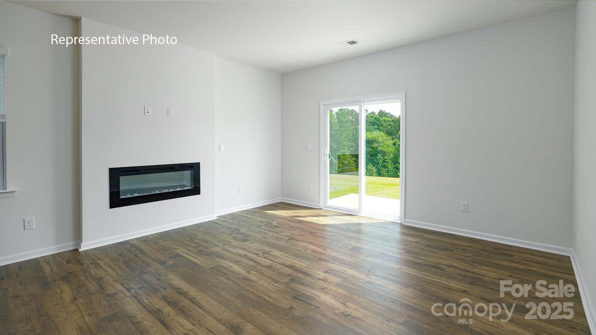 2668 Goose Fair Road Maiden, NC 28650 - Photo 10 of 28 a view of an empty room with wooden floor and a window