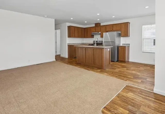 a kitchen with stainless steel appliances a refrigerator and a microwave