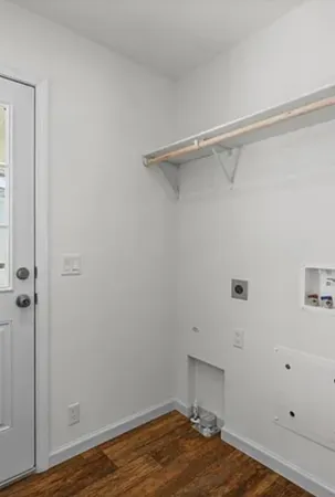 a room with a walk in closet and wooden floor