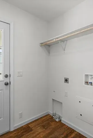 a room with a walk in closet and wooden floor