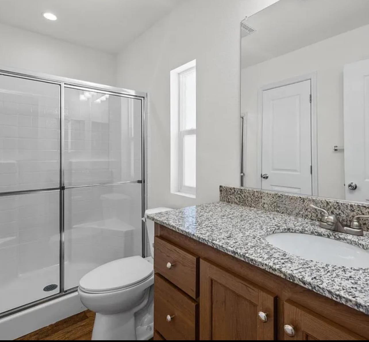 2240 Golden Oak Lane, Unit 104 Merced, CA 95341 - Photo 8 of 19 a bathroom with a granite countertop sink toilet and shower