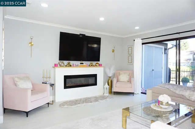 a living room with furniture and kitchen view