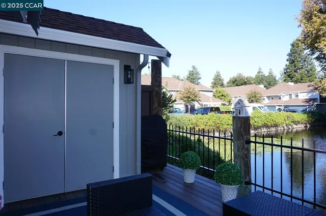 a view of a chairs and table on the wooden deck