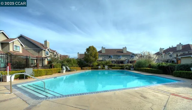 an outdoor space with pool and lake view
