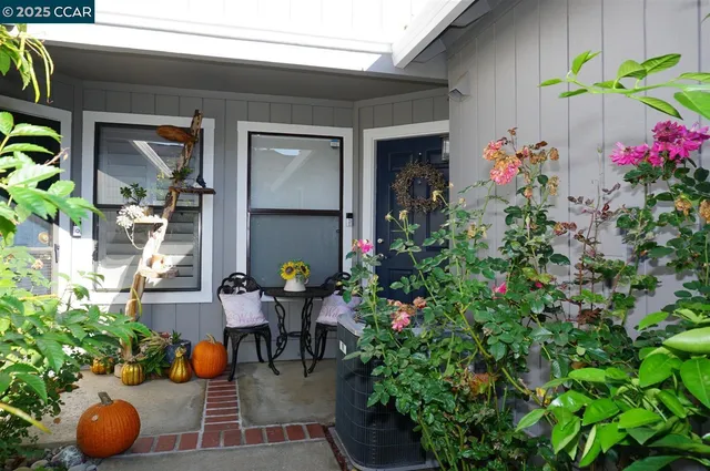a group of people sitting in front of a house