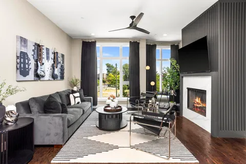a view of staircase with lots of frames on wall and wooden floor
