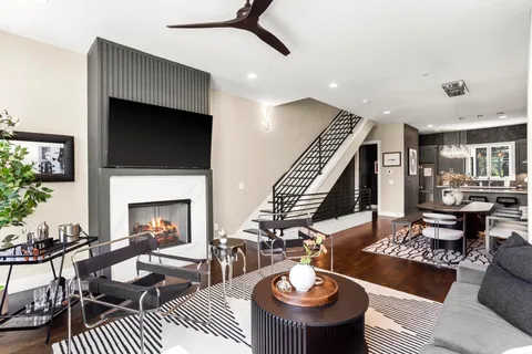a living room with patio furniture and a flat screen tv