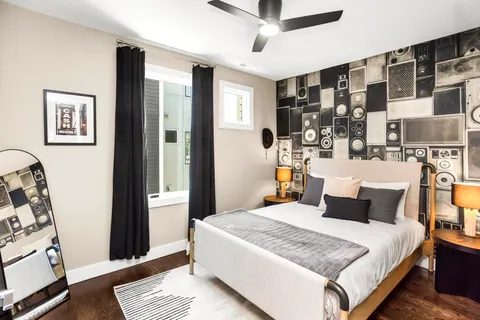 a living room with furniture a flat screen tv and a window