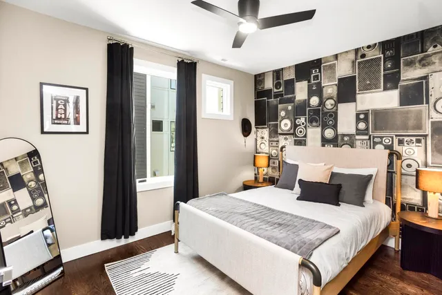 a living room with furniture a flat screen tv and a window