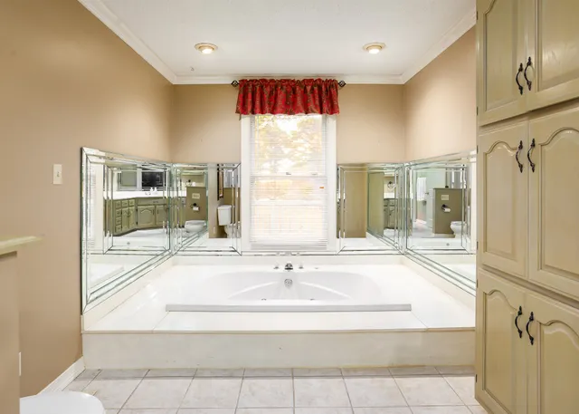 a spacious bathroom with a granite countertop sink and a mirror