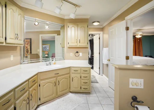 a large white kitchen with stainless steel appliances granite countertop a lot of counter space and a sink
