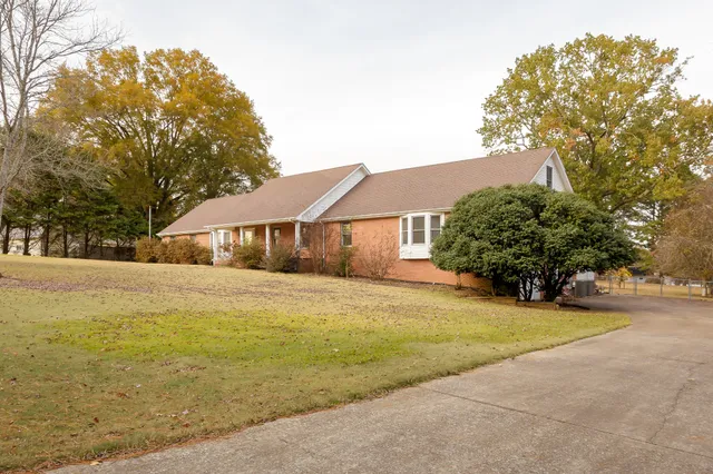 a front view of house with yard and trees