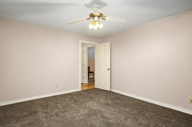 a spacious bathroom with a shower a sink and a mirror