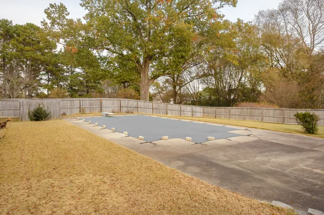 a view of a house with swimming pool and a yard