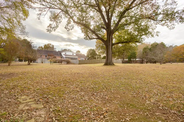 a view of yard with swimming pool and trees