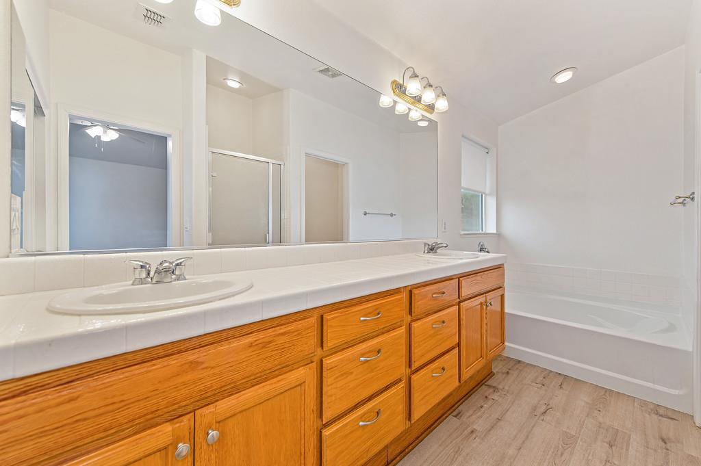 3524 Riojo Way Rancho Cordova, CA 95670 - Photo 36 of 47 a spacious bathroom with double sink a large mirror and a bathtub