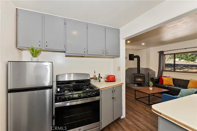 a kitchen with stainless steel appliances a stove a refrigerator sink and cabinets
